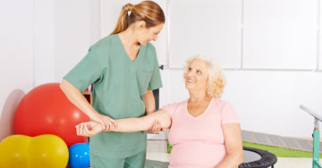 caregiver doing massage in the hands of patient
