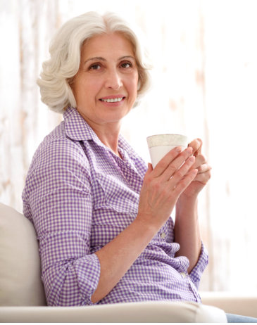 senior patient holding a cup
