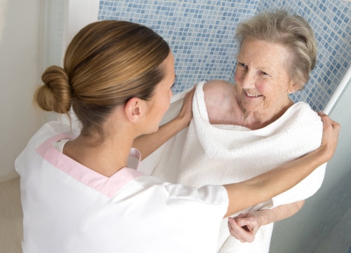 senior woman taking a bath with her caregiver